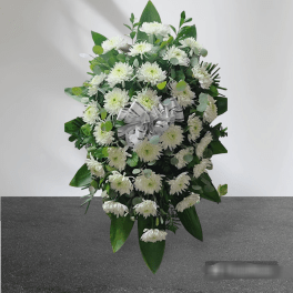 White chrysanthemum standing spray with a white ribbon bow