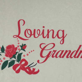 Quilted fabric with pink "Loving Grandma" text and rose graphics