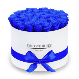 Round box filled with vivid blue roses and tied with a blue ribbon
