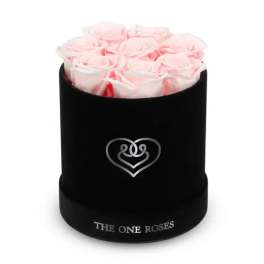 Pink roses arranged in a black round box