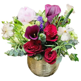 Bouquet of pink and purple flowers in a gold vase