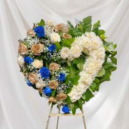 Heart-shaped floral wreath of roses on an easel