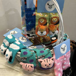 Basket of colorful animal-themed socks with blue tags