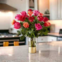 Bouquet of pink and red roses in a clear glass vase