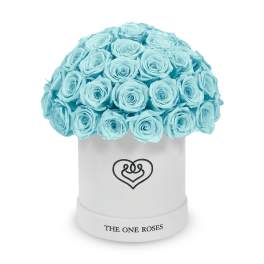 Blue rose bouquet in a white hatbox with a heart logo