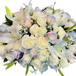 White roses and lilies with pastel-tinted roses in a bouquet