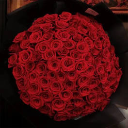 Large bouquet of red roses wrapped in black paper
