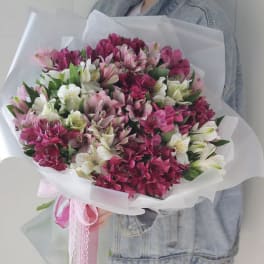 Bouquet of pink, white, and magenta alstroemeria wrapped in white paper