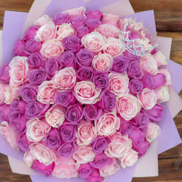 Bouquet of pink and lavender roses with a small jeweled crown