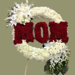 Floral standing tribute shaped like the word LOVE in red and white flowers