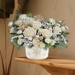 White rose arrangement in a snowflake-decorated vase