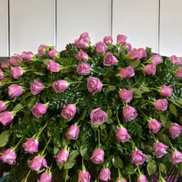 Large arrangement of pink roses over dense greenery