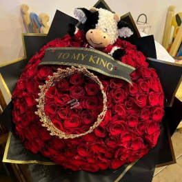 Large red rose bouquet with a plush cow and a "TO MY KING" ribbon