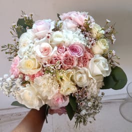 Bouquet of pink and white roses with small filler flowers