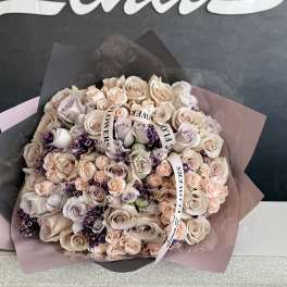 Large bouquet of pale pink and cream roses with purple accents