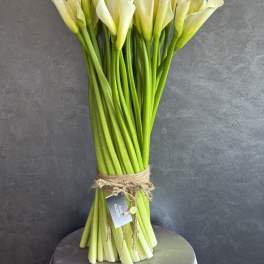Bouquet of white calla lilies tied with twine
