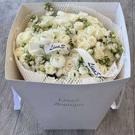 White rose bouquet in a gift box with ribbon