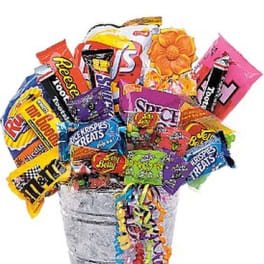 Bucket filled with assorted candy bars and colorful streamers