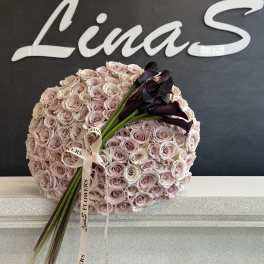 Round bouquet of pale pink roses with dark calla lilies and ribbon