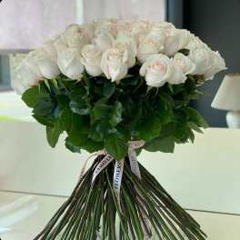 Bouquet of pale pink roses with long stems and ribbon ties