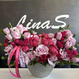 Pink and red rose bouquet in a silver textured vase