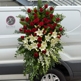 Tall standing floral spray with red roses and white lilies