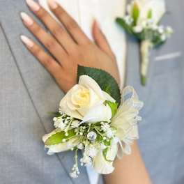 White rose wrist corsage with ribbon and small white accents