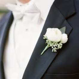White boutonniere on a dark suit lapel