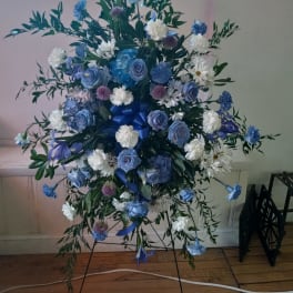 Blue and white floral standing spray on an easel