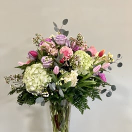 Mixed pink and lavender bouquet in a clear glass vase