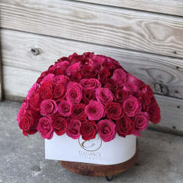 Large dome of hot pink roses in a white box