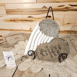 Decorative angel wing memorial plaque on a metal stand