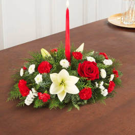Low floral centerpiece with a red taper candle and red, white blooms