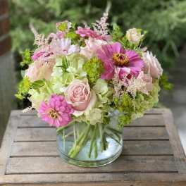 Pink and cream bouquet in a clear glass vase