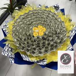 Bouquet made of folded dollar bills with yellow roses in the center