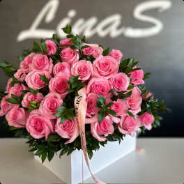 Pink rose bouquet in a white box with a ribbon
