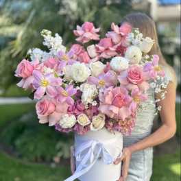 Large pink and white bouquet in a white hat box with ribbon