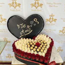 Heart-shaped rose box with red and white roses and gold chocolates