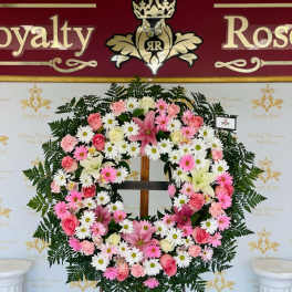 Pink and white floral wreath on a standing easel