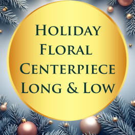 Holiday floral centerpiece sign with pine branches and ornaments