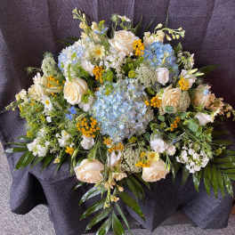 Large bouquet of white and blue flowers with yellow accents