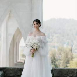 Bride in a white gown holding a white bouquet