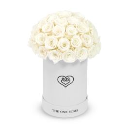 White roses arranged in a round white hat box