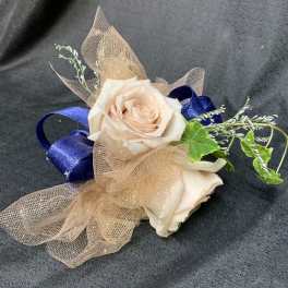 Two pale roses with blue ribbon and tan mesh wrap