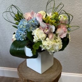 Mixed pastel bouquet in a white square vase