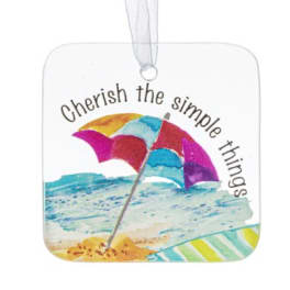 Square hanging ornament with beach umbrella illustration and the words 'Cherish the simple things'.