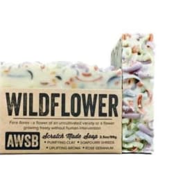 Rustic bar of wildflower-scented soap with colorful shreds and kraft paper label