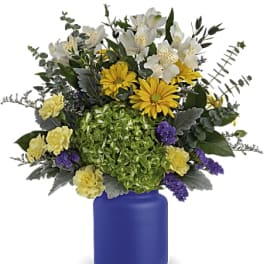 Bouquet of white and yellow flowers in a blue vase