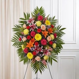 Standing floral spray with mixed bright flowers on an easel