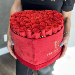 Heart-shaped box filled with red roses